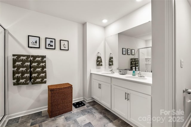 461 Misty Law Ln, Clover, SC 29710 - bathroom with baseboards, double vanity, a shower stall, stone finish floors, and recessed lighting