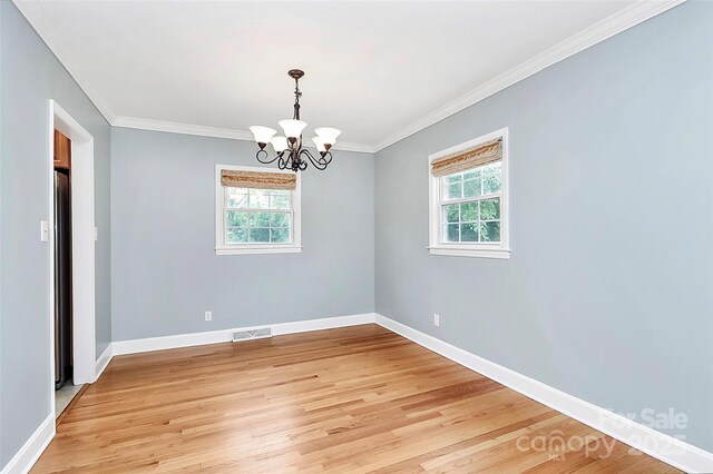 6908 Lancer Dr, Charlotte, NC 28226 - spare room featuring healthy amount of natural light, light wood-style flooring, a chandelier, crown molding, and baseboards