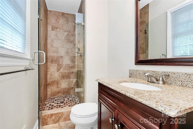 6908 Lancer Dr, Charlotte, NC 28226 - full bathroom with vanity, a stall shower, healthy amount of natural light, and toilet