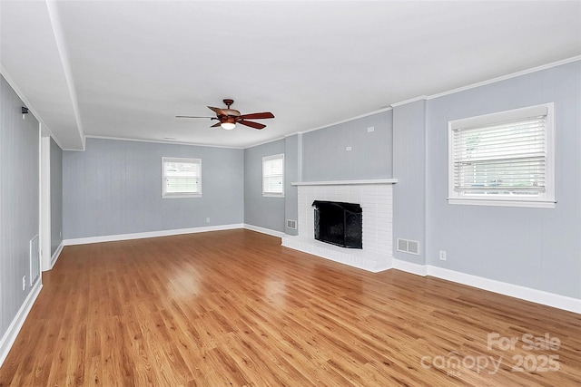6908 Lancer Dr, Charlotte, NC 28226 - unfurnished living room featuring crown molding, ceiling fan, light wood-type flooring, a brick fireplace, and baseboards