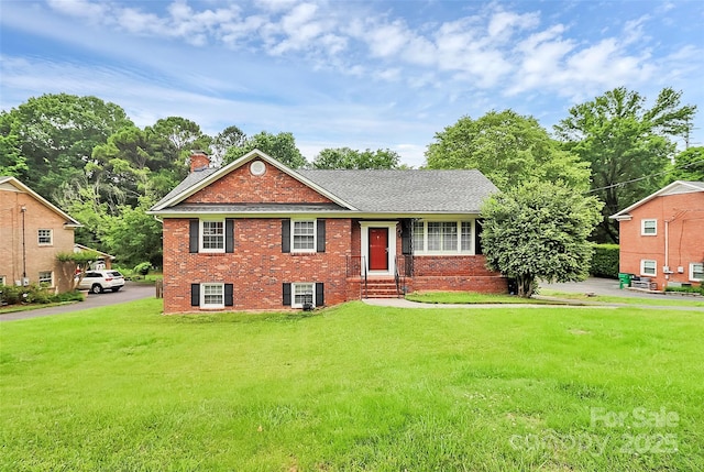 6908 Lancer Dr, Charlotte, NC 28226 - view of front of home with a chimney, brick siding, a front lawn, and driveway