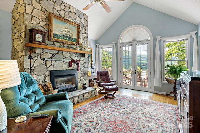 65 Timber Park Dr, Black Mountain, NC 28711 - sitting room with vaulted ceiling, ceiling fan, a stone fireplace, french doors, and wood finished floors
