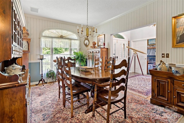 65 Timber Park Dr, Black Mountain, NC 28711 - dining area with wallpapered walls, ornamental molding, a textured ceiling, and wood finished floors