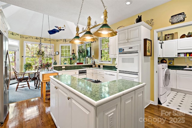 65 Timber Park Dr, Black Mountain, NC 28711 - kitchen featuring washer / dryer, white appliances, white cabinetry, a peninsula, and dark wood finished floors