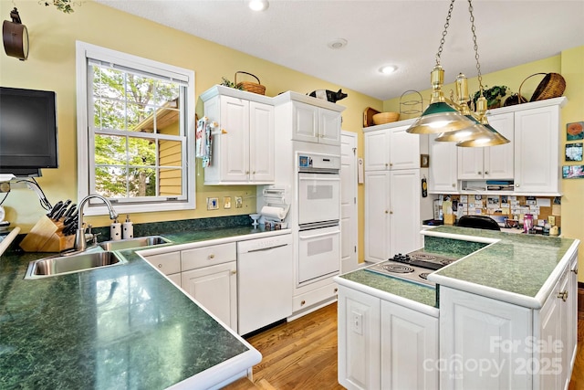 65 Timber Park Dr, Black Mountain, NC 28711 - kitchen featuring white appliances, light wood-type flooring, white cabinetry, recessed lighting, and tasteful backsplash