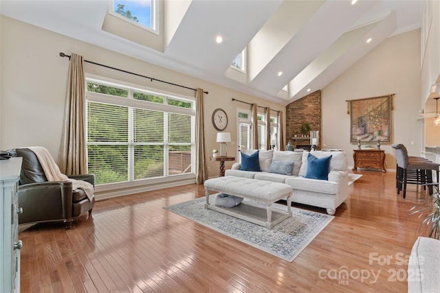 10620 Euclid Ave NW, Concord, NC 28027 - living room with a skylight, high vaulted ceiling, light wood finished floors, and recessed lighting