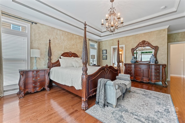 10620 Euclid Ave NW, Concord, NC 28027 - bedroom featuring a chandelier, wood finished floors, a raised ceiling, wallpapered walls, and crown molding