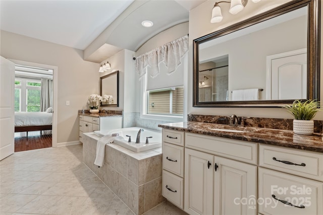 10620 Euclid Ave NW, Concord, NC 28027 - bathroom with a garden tub, vanity, ensuite bath, a shower with door, and baseboards