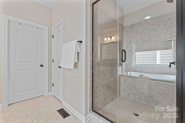 10620 Euclid Ave NW, Concord, NC 28027 - bathroom featuring a shower stall, tile patterned flooring, and tiled tub