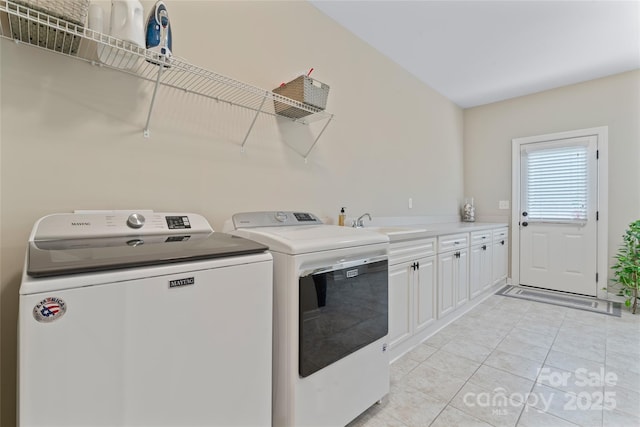 10620 Euclid Ave NW, Concord, NC 28027 - washroom with independent washer and dryer, cabinet space, and light tile patterned floors
