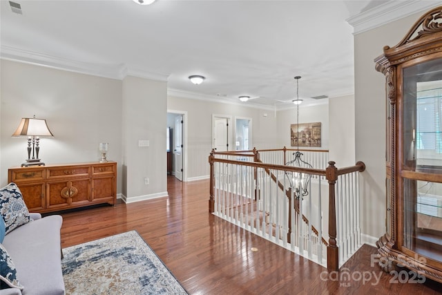 10620 Euclid Ave NW, Concord, NC 28027 - corridor with an upstairs landing, wood finished floors, baseboards, and crown molding