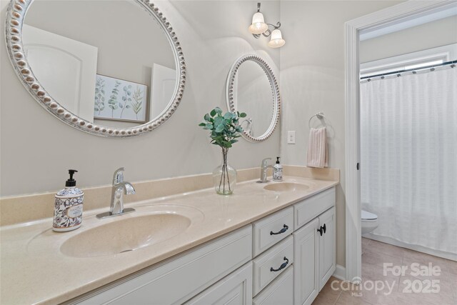 10620 Euclid Ave NW, Concord, NC 28027 - bathroom with tile patterned floors, toilet, double vanity, and a shower with curtain