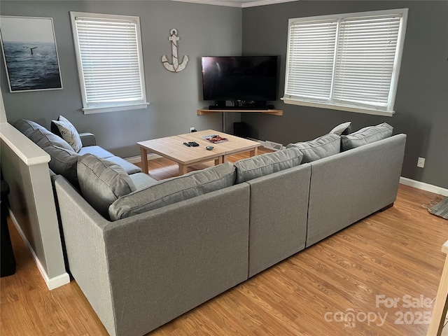 132 Marina Ln, Mooresville, NC 28117 - living room featuring wood finished floors, baseboards, and crown molding