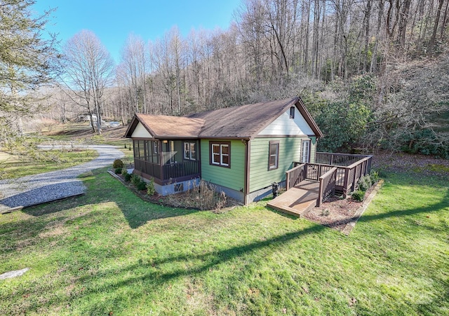 7150 Yellow Creek Rd, Robbinsville, NC 28771 - view of side of home with a yard, a deck, roof with shingles, and a wooded view