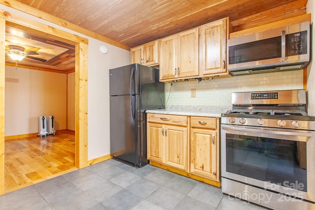 7150 Yellow Creek Rd, Robbinsville, NC 28771 - kitchen featuring appliances with stainless steel finishes, wood ceiling, tasteful backsplash, radiator heating unit, and light tile patterned floors