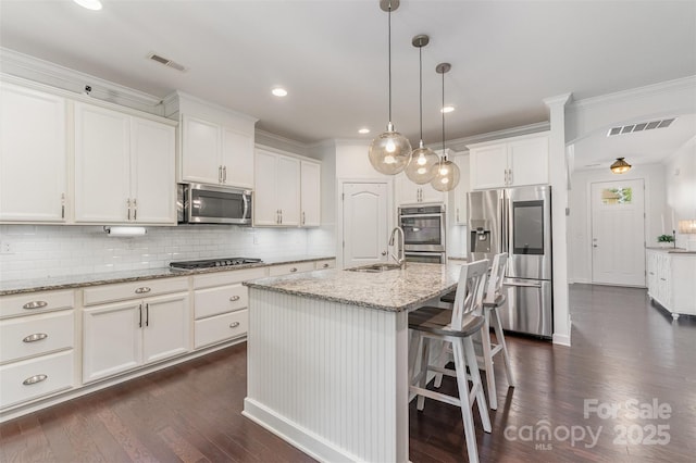 755 Lagan Ct, Fort Mill, SC 29715 - kitchen with stainless steel appliances, a sink, dark wood-style flooring, decorative backsplash, and white cabinets