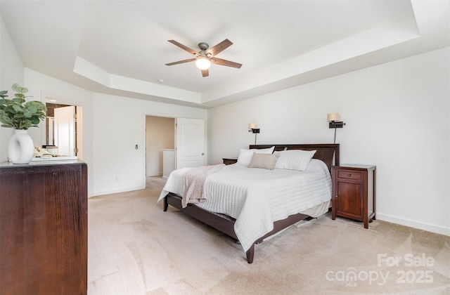 755 Lagan Ct, Fort Mill, SC 29715 - bedroom featuring a tray ceiling, baseboards, light carpet, and ceiling fan