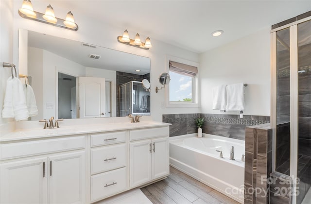 755 Lagan Ct, Fort Mill, SC 29715 - bathroom with a shower stall, double vanity, a bath, recessed lighting, and wood finished floors