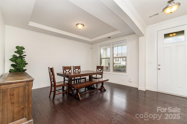 755 Lagan Ct, Fort Mill, SC 29715 - dining space featuring arched walkways, dark wood finished floors, a raised ceiling, and baseboards