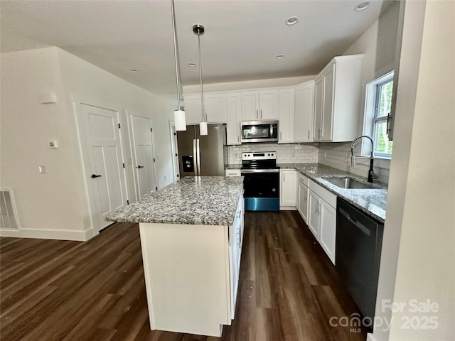 206 Cascade Ridge Rd, Fairview, NC 28730 - kitchen featuring stainless steel appliances, a sink, dark wood finished floors, light stone counters, and recessed lighting