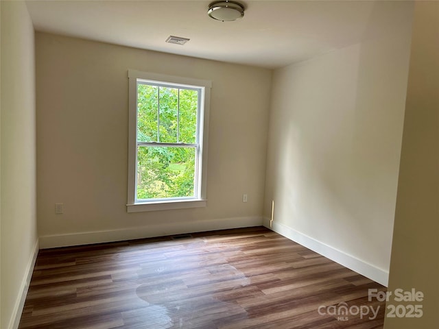 206 Cascade Ridge Rd, Fairview, NC 28730 - unfurnished room with plenty of natural light, wood finished floors, and baseboards