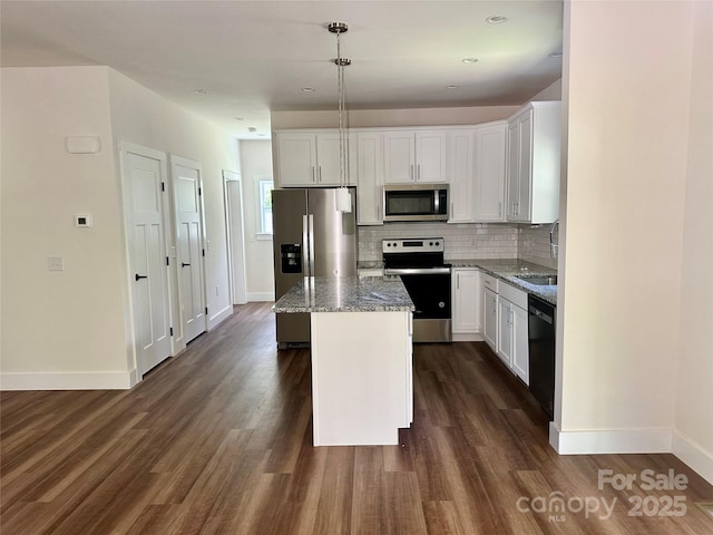 206 Cascade Ridge Rd, Fairview, NC 28730 - kitchen featuring appliances with stainless steel finishes, a center island, light stone countertops, baseboards, and dark wood-type flooring