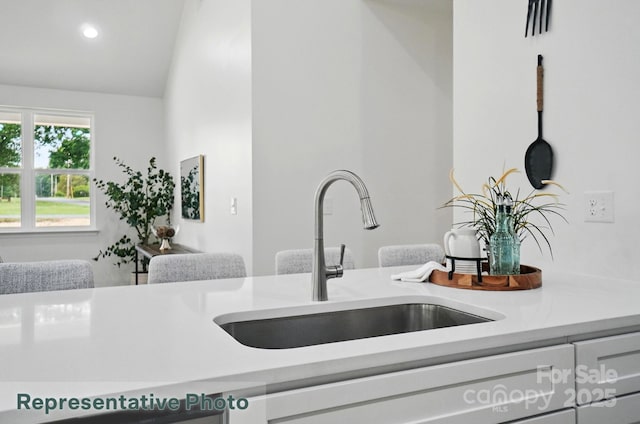 2116A Glenwood St, Kannapolis, NC 28083 - kitchen with a sink, light countertops, vaulted ceiling, and recessed lighting
