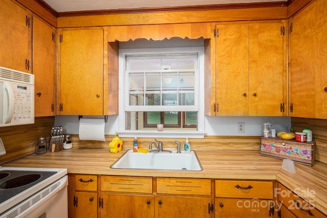 3120 7th Street Dr NE, Hickory, NC 28601 - kitchen with white appliances, light countertops, brown cabinets, and ornamental molding