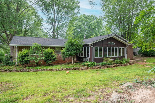 3120 7th Street Dr NE, Hickory, NC 28601 - rear view of house with a yard and brick siding