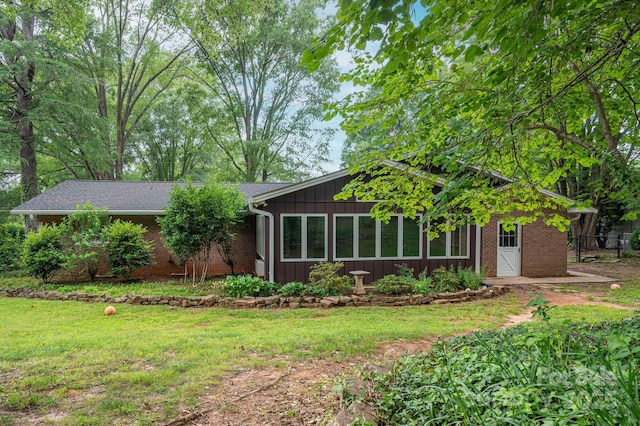 3120 7th Street Dr NE, Hickory, NC 28601 - view of front of home featuring a front yard, brick siding, and board and batten siding