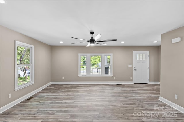 933 Old Charlotte Rd, Concord, NC 28027 - unfurnished living room featuring ceiling fan, recessed lighting, light wood-style flooring, and baseboards