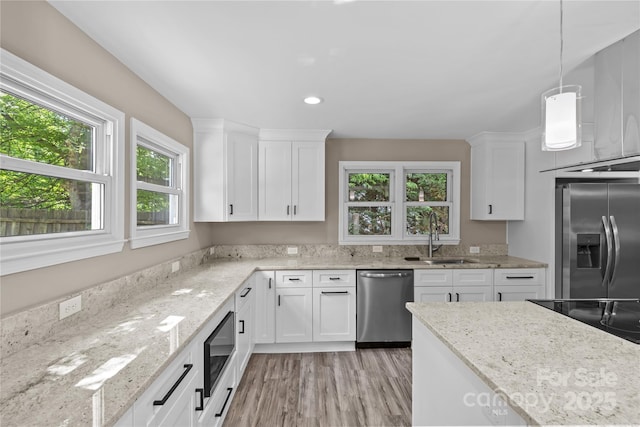 933 Old Charlotte Rd, Concord, NC 28027 - kitchen with black appliances, a sink, light wood-type flooring, white cabinetry, and recessed lighting