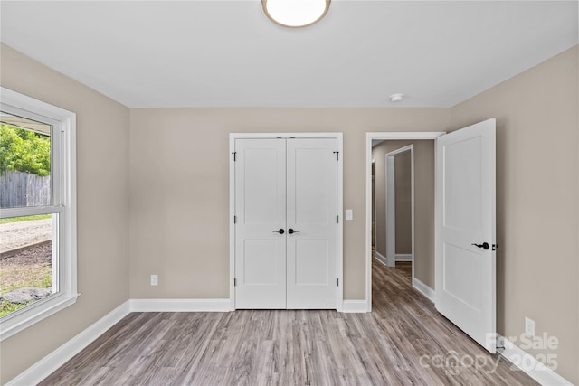933 Old Charlotte Rd, Concord, NC 28027 - unfurnished bedroom with wood finished floors, baseboards, and a closet