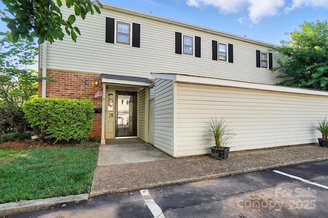 5947 Quail Hollow Rd Unit A, Charlotte, NC 28210 - view of front of house with brick siding and uncovered parking