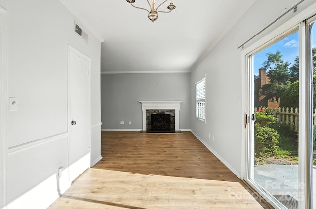 5947 Quail Hollow Rd Unit A, Charlotte, NC 28210 - unfurnished living room with wood finished floors, crown molding, a chandelier, and a high end fireplace