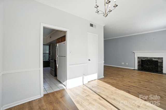 5947 Quail Hollow Rd Unit A, Charlotte, NC 28210 - unfurnished living room featuring wood finished floors, a chandelier, crown molding, and a premium fireplace