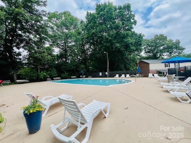 5947 Quail Hollow Rd Unit A, Charlotte, NC 28210 - community pool featuring a patio area and view of wooded area