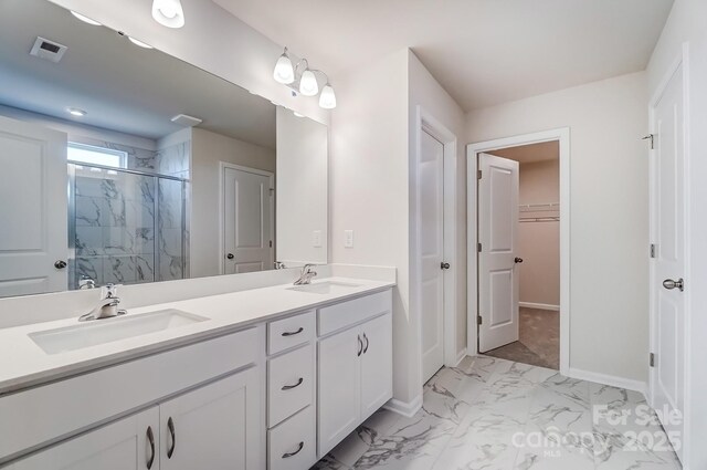 2648 Tillman St, Monroe, NC 28112 - bathroom with marble finish floors, a marble finish shower, double vanity, baseboards, and a spacious closet