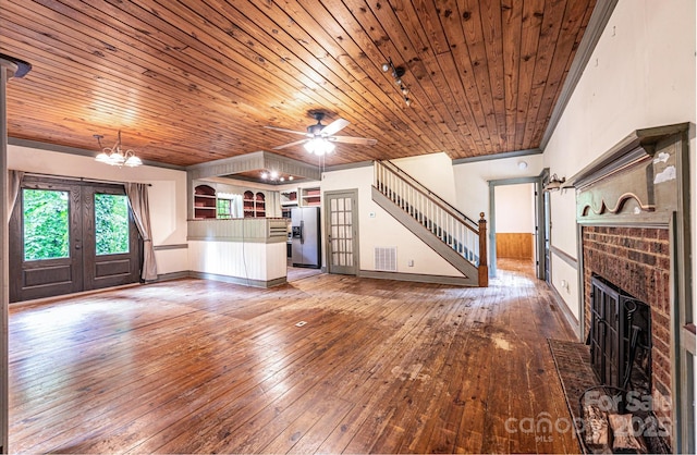 809 Westminster Cir SW, Lenoir, NC 28645 - unfurnished living room featuring hardwood / wood-style flooring, wooden ceiling, a brick fireplace, french doors, and a chandelier