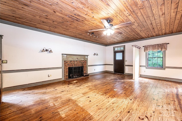 809 Westminster Cir SW, Lenoir, NC 28645 - unfurnished living room with wood ceiling, wood-type flooring, ceiling fan, a brick fireplace, and baseboards