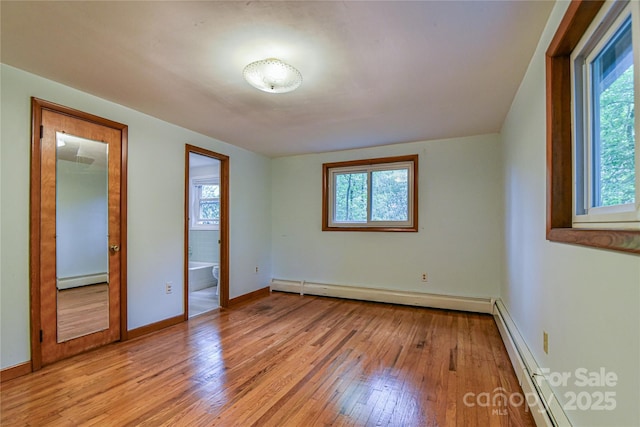5 Old Cove Rd, Black Mountain, NC 28711 - unfurnished bedroom with a baseboard heating unit and multiple windows