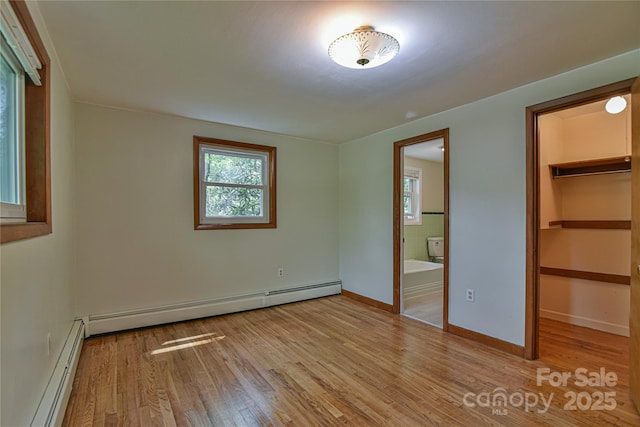 5 Old Cove Rd, Black Mountain, NC 28711 - unfurnished bedroom featuring baseboard heating, multiple windows, and wood finished floors