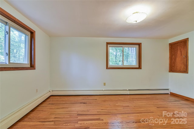 5 Old Cove Rd, Black Mountain, NC 28711 - unfurnished room with plenty of natural light, light wood-style floors, baseboards, and a baseboard radiator