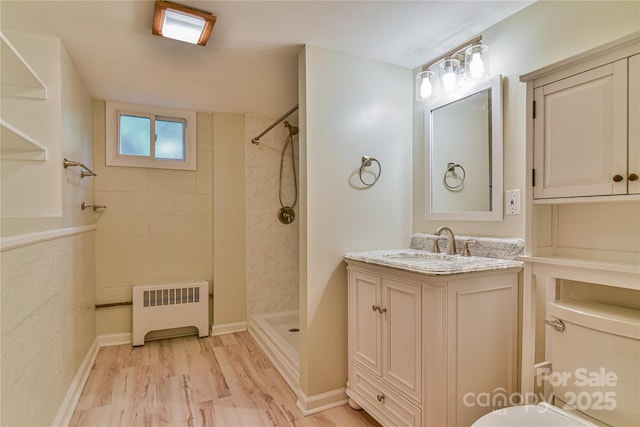 5 Old Cove Rd, Black Mountain, NC 28711 - full bath featuring radiator heating unit, tiled shower, vanity, wood finished floors, and toilet