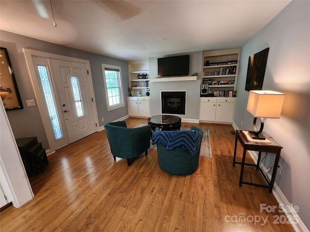 2904 E Brocktown Rd, Moravian Falls, NC 28654 - living room with a fireplace, light wood-type flooring, baseboards, and built in shelves