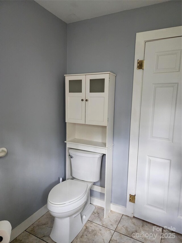 2904 E Brocktown Rd, Moravian Falls, NC 28654 - bathroom with toilet, baseboards, and tile patterned floors