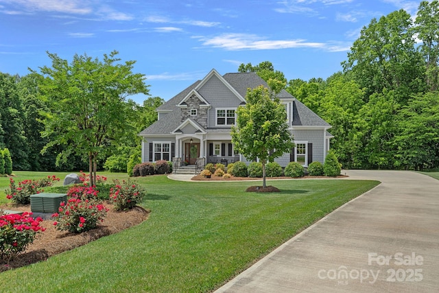 224 Hidden Meadows Dr, Mooresville, NC 28117 - view of front facade featuring covered porch, a front lawn, and roof with shingles