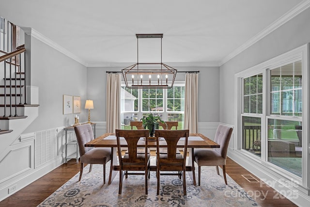224 Hidden Meadows Dr, Mooresville, NC 28117 - dining space featuring a chandelier, crown molding, stairway, wainscoting, and dark wood finished floors