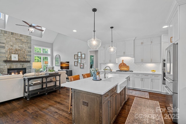 224 Hidden Meadows Dr, Mooresville, NC 28117 - kitchen featuring open floor plan, a ceiling fan, white cabinets, gas stovetop, and vaulted ceiling