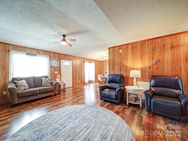 4115 Jenkins Rd, Marshville, NC 28103 - living room with wooden walls, a ceiling fan, a textured ceiling, wood finished floors, and a chandelier